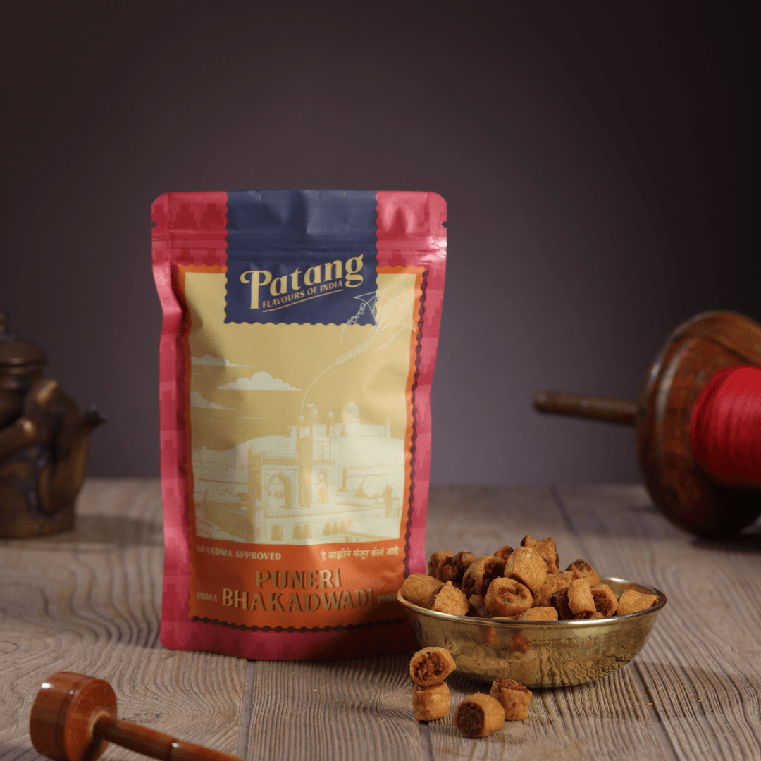 Patang Puneri Bhakadwao packaging with snacks on a wooden surface