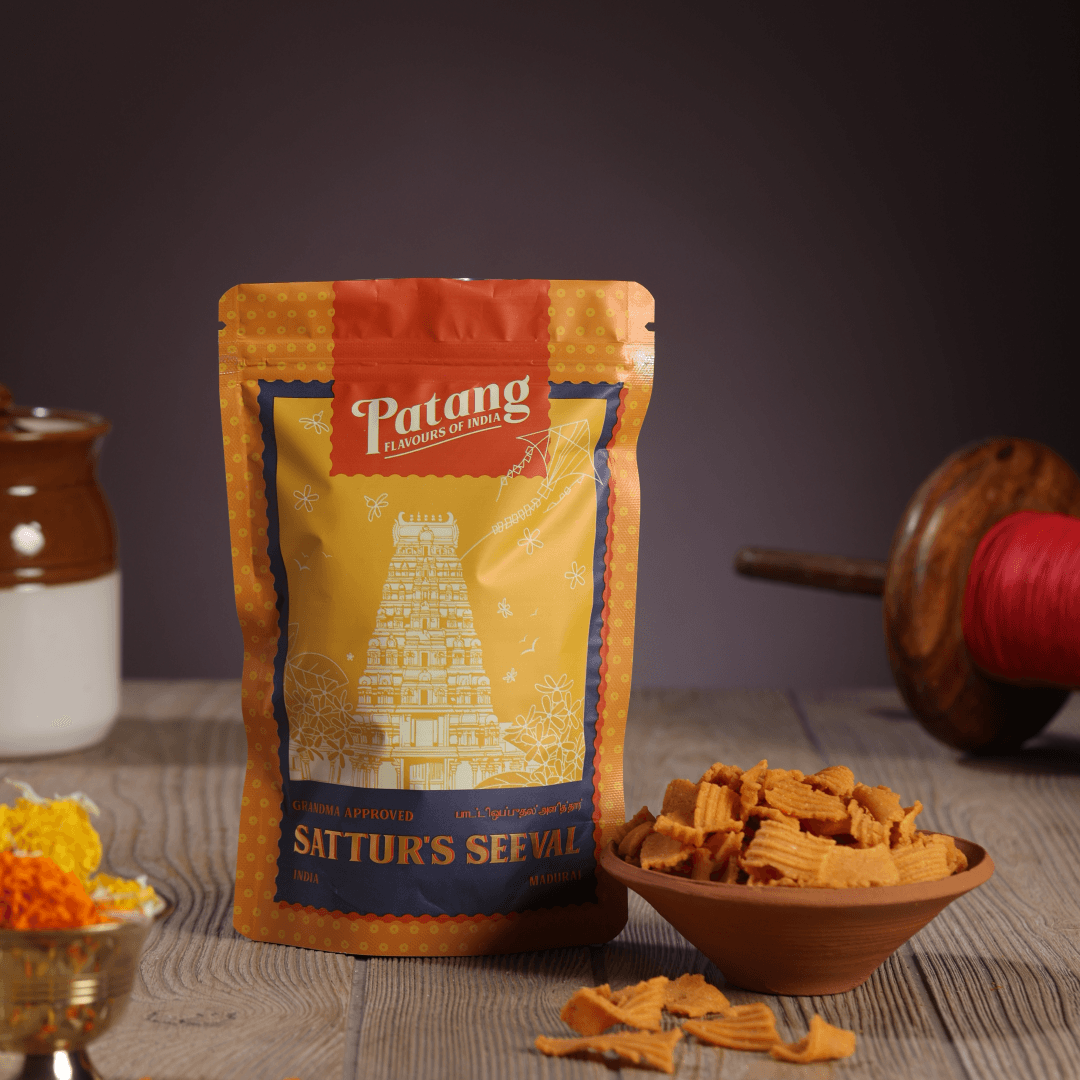Patang Sattur's Sevval packaging with snacks on a wooden surface