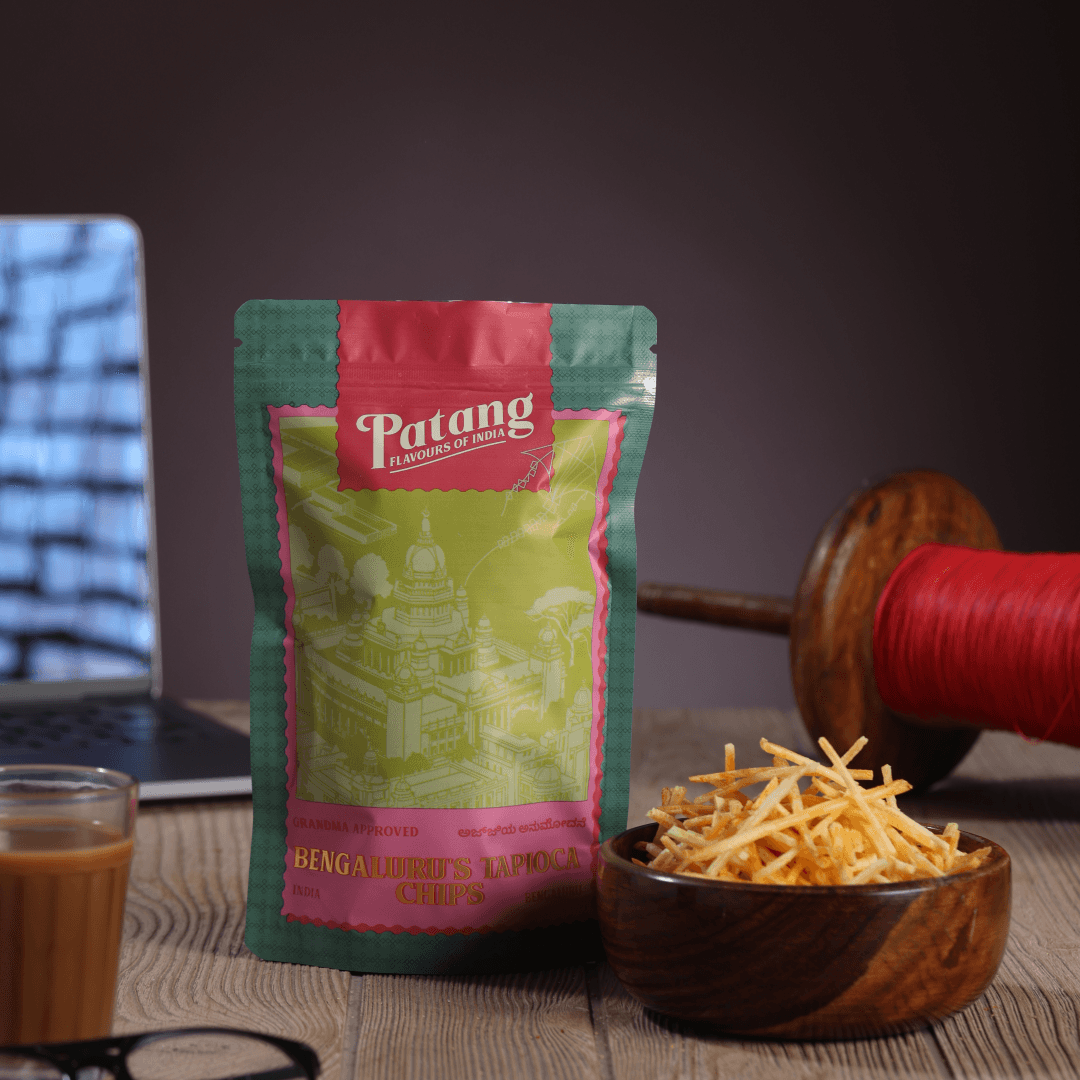 Patang snack package with a bowl of snacks and a cup of coffee on a table.
