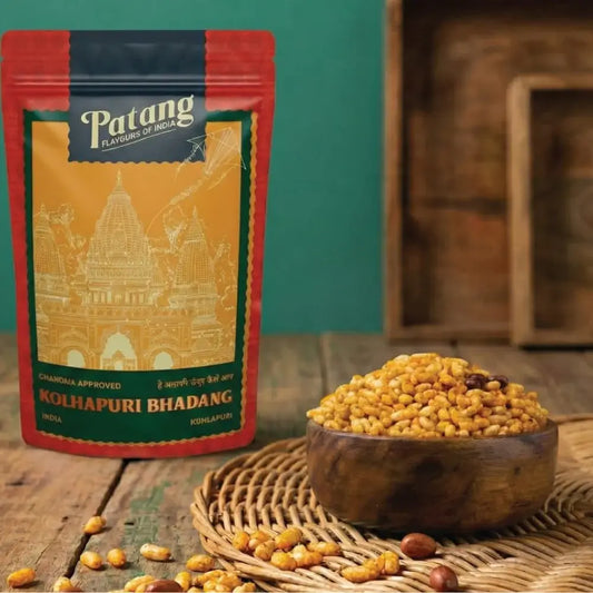 Patang Kolhapuri Bhadang packaging with a bowl of seeds on a wooden surface.