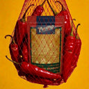 Red chili peppers in a net bag with a Patang package on a yellow background