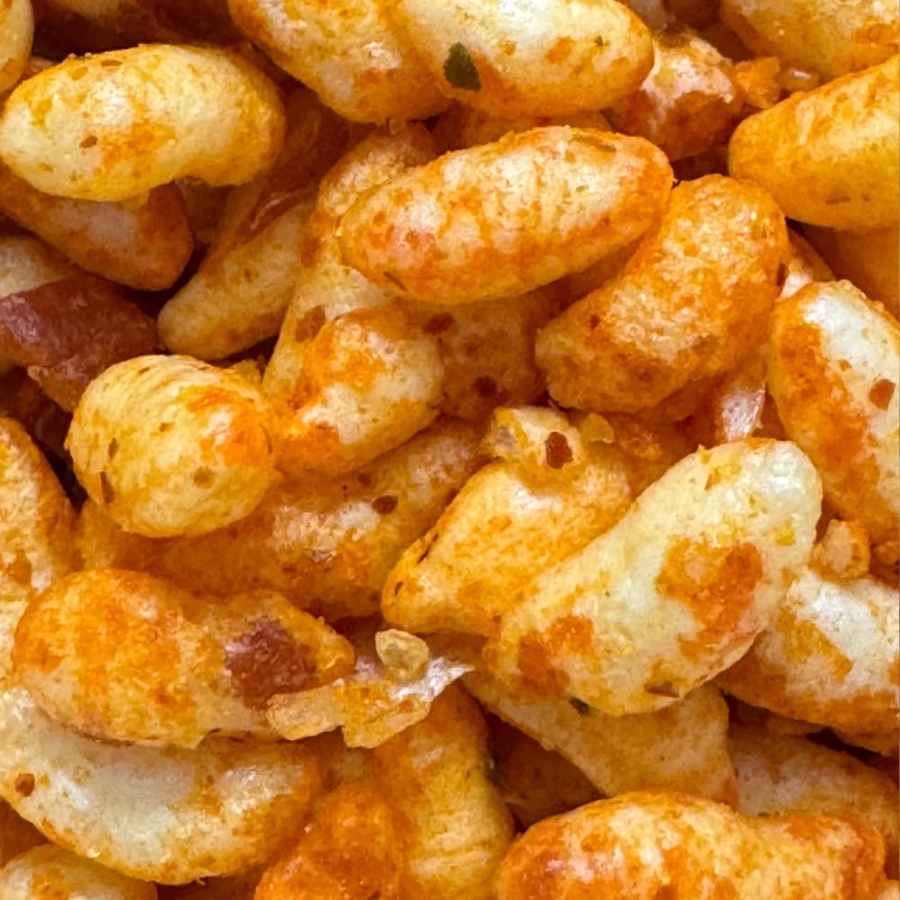 Close up of healthy Kolhapuri Bhadang showing spicy puffed rice, peanuts, and garlic roasted in groundnut oil