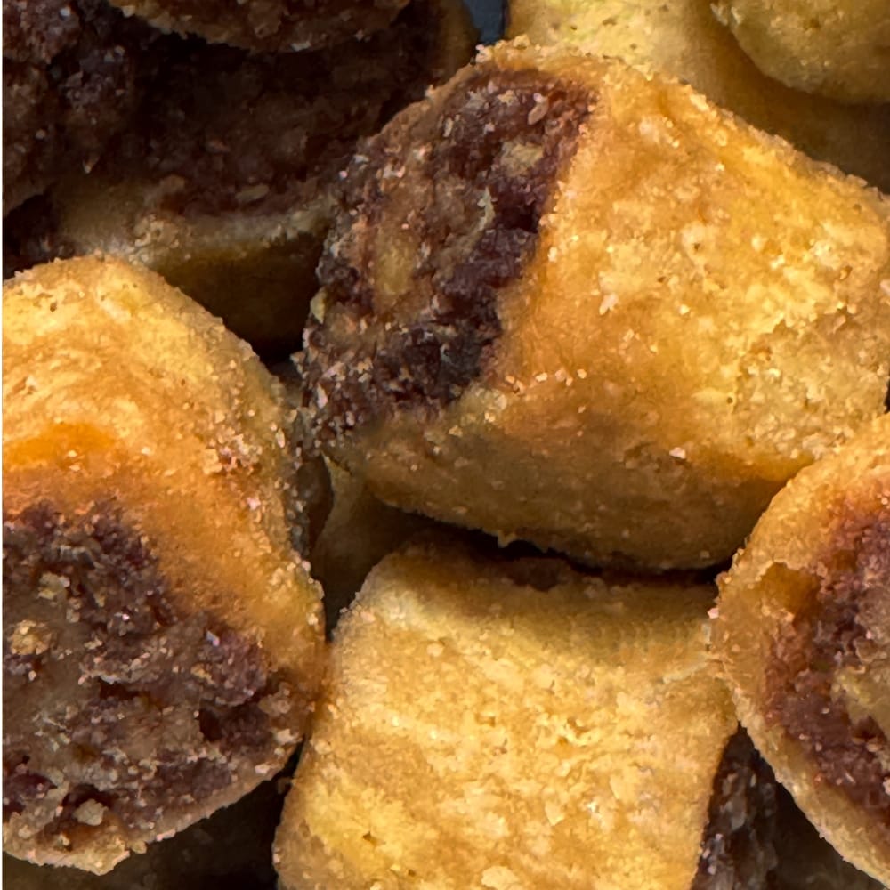 Close up texture of mini crispy Bhakarwadi snack showing the traditional spicy coconut and sesame filling