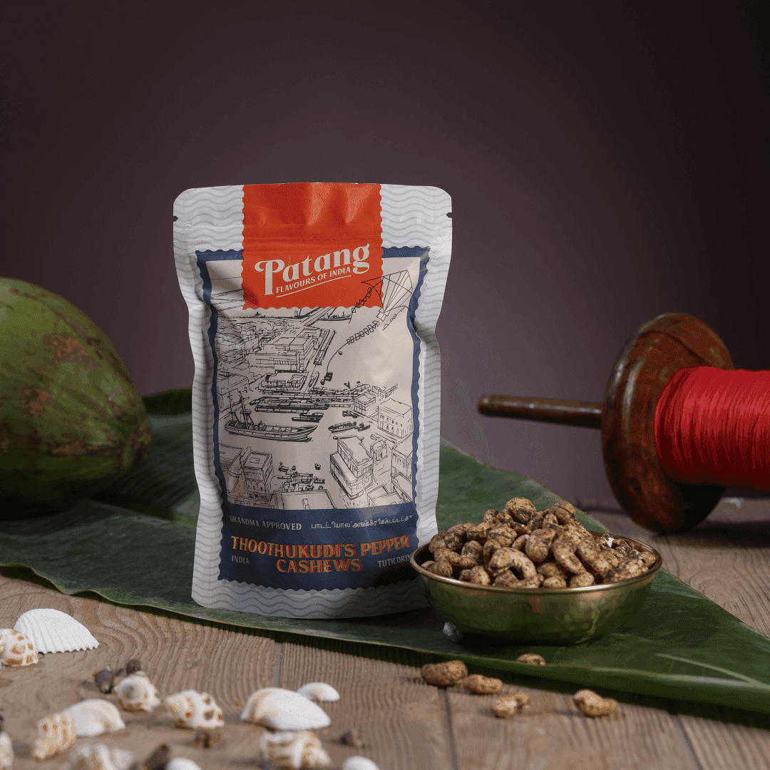 Patang cashew package with cashews on a leafy background