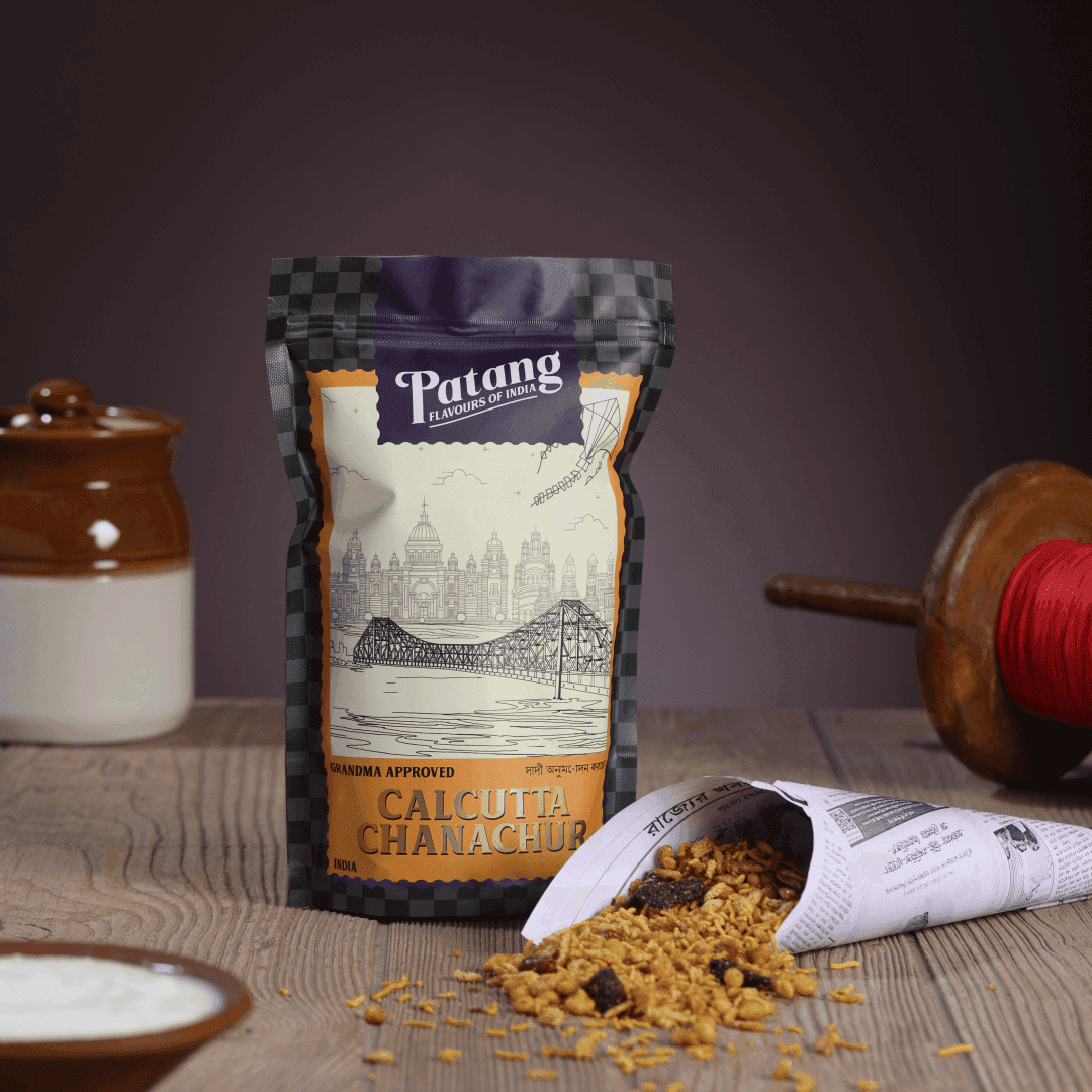 Patang Calcutta Chanachur spice packet on a wooden surface with a blurred background