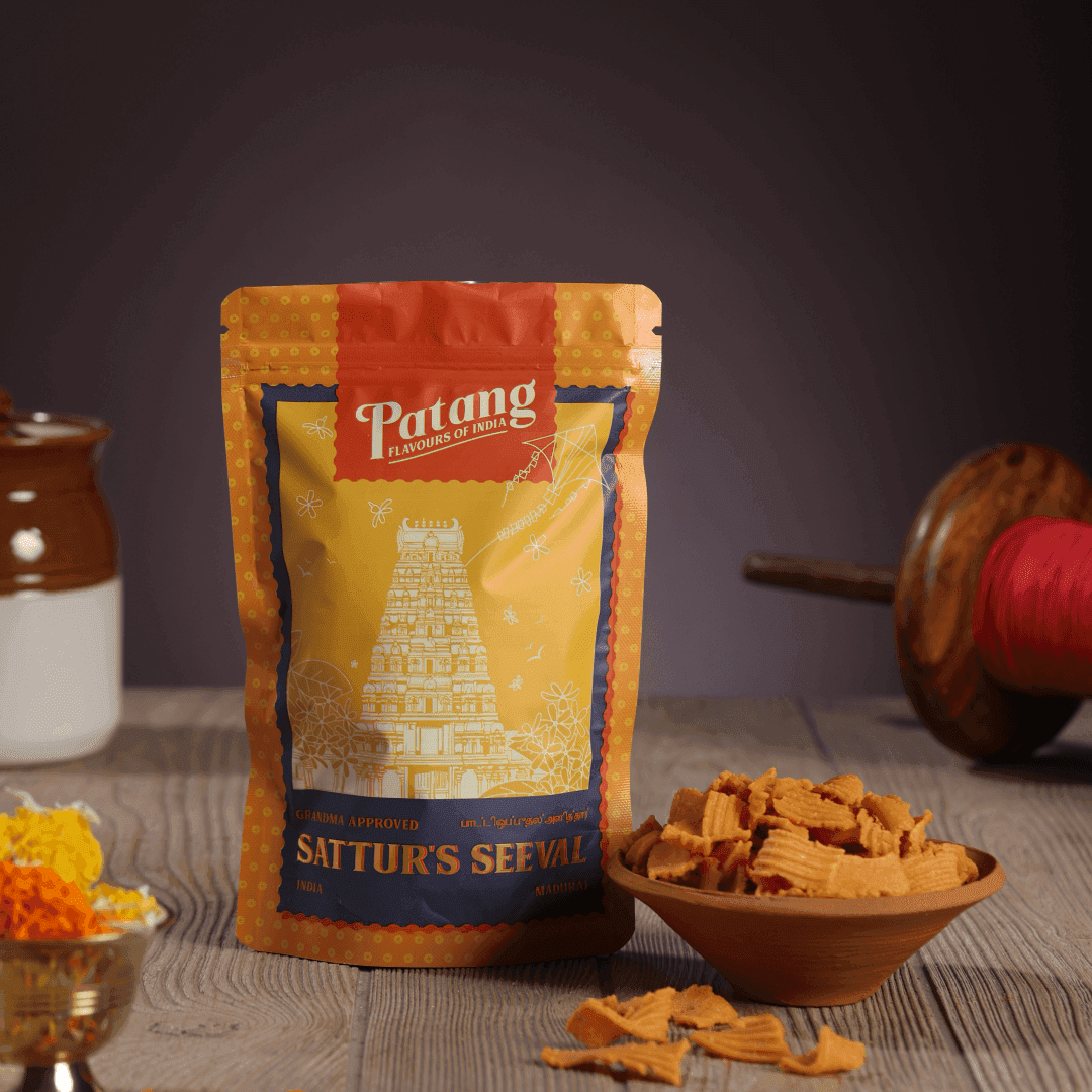 Patang Sattur's Sevval packaging with snacks on a wooden surface